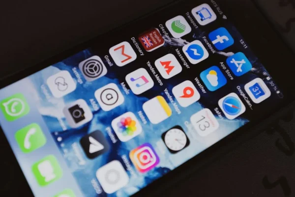 Close-up of a smartphone displaying popular social media and productivity apps on its screen.