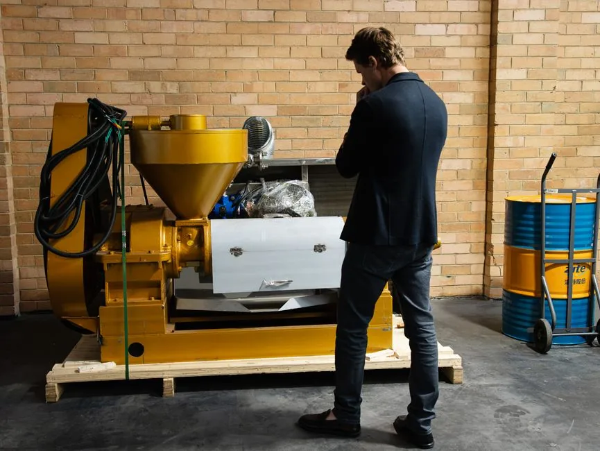 Entrepreneur examining industrial machinery in a modern warehouse setting.