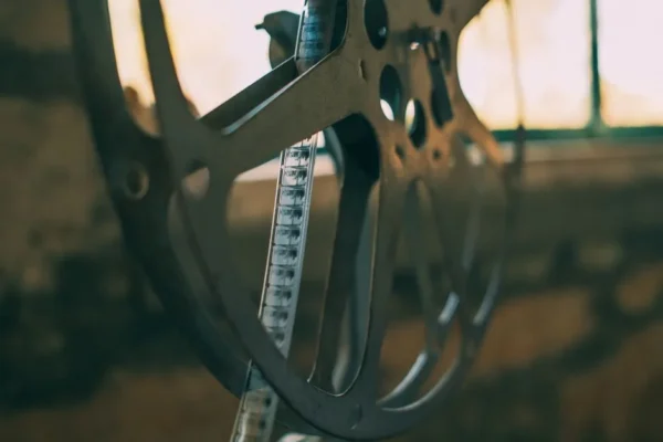 Artistic shot of a vintage film reel with soft light creating a nostalgic atmosphere.